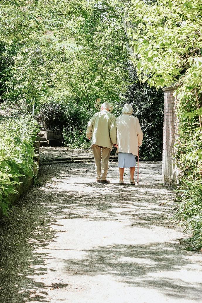 man and woman walking on road during daytime